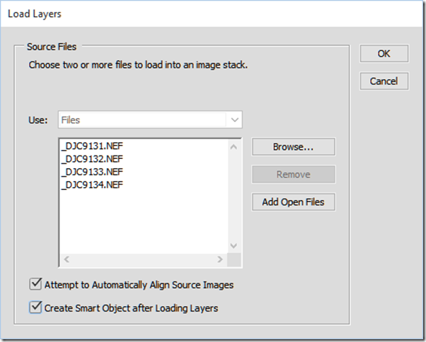 With Photoshop CC you can create a layer stack, align the layers, and create a smart object all in one step